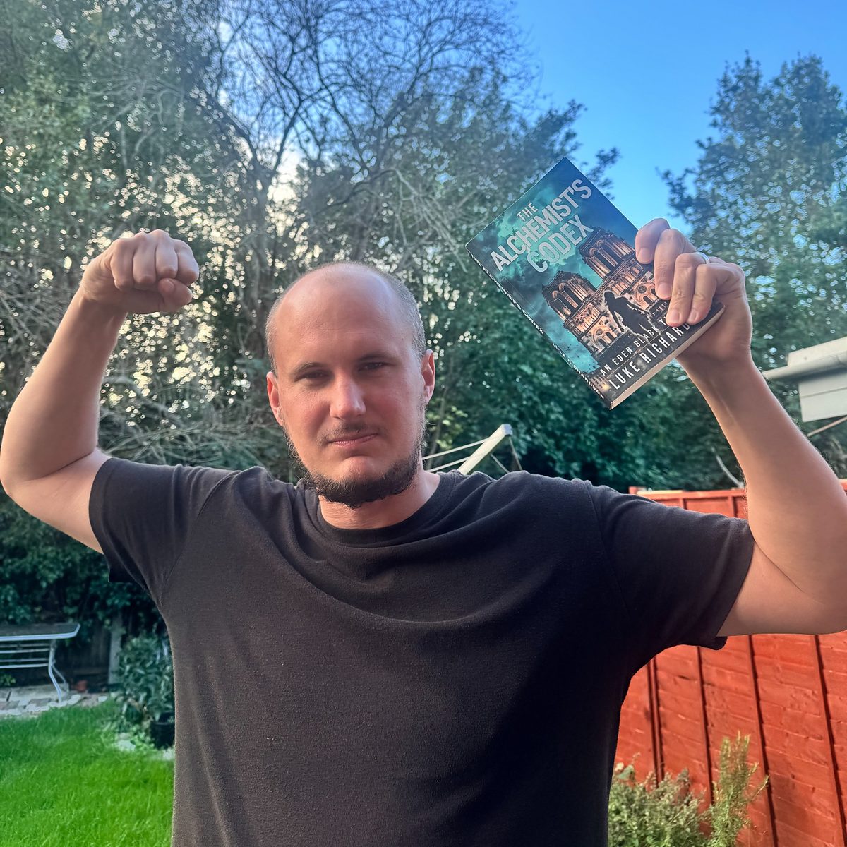 Author Luke Richardson celebrating launch day with a paperback of The Alchemist’s Codex