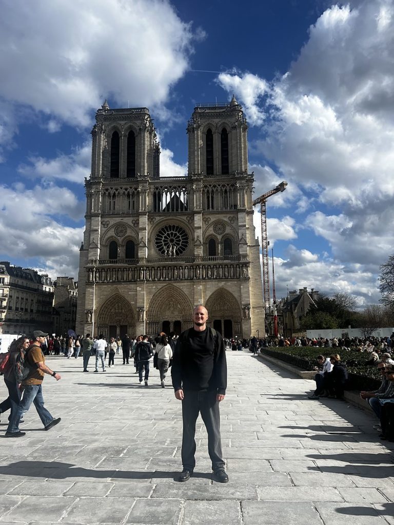 Luke Richardson outside Notre-Dame de Paris while researching The Alchemist’s Codex