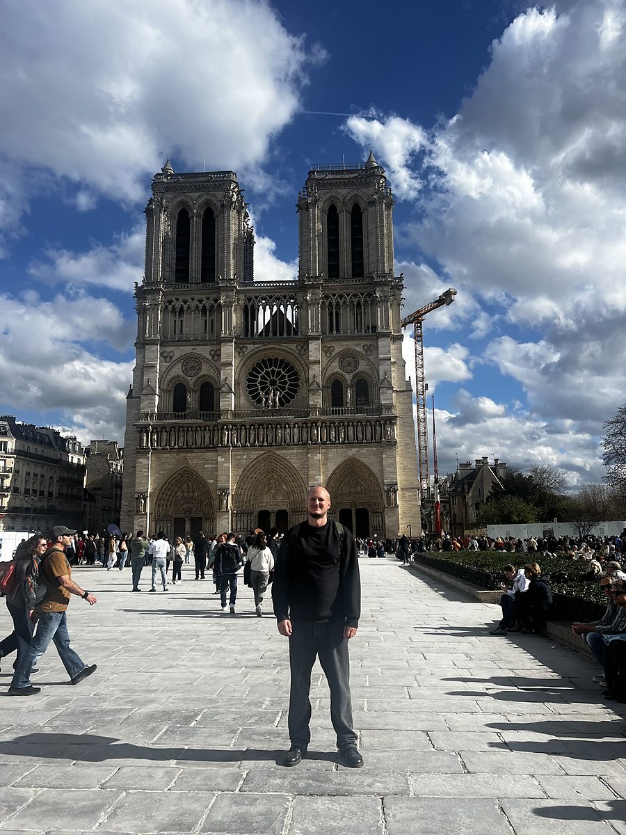 Luke Richardson outside Notre-Dame de Paris while researching The Alchemist’s Codex