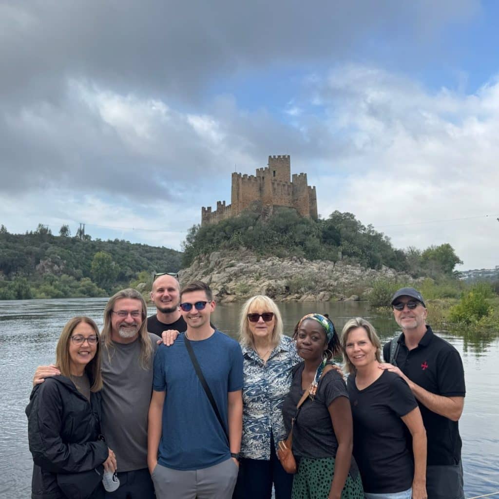 On the Trail of the Templars Adventure Society Expedition group beside the River Tagus with Almourol Castle behind