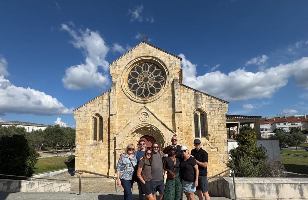 Adventure Society Expedition group in front of the Templar church of Santa Maria do Olival in Tomar, Portugal