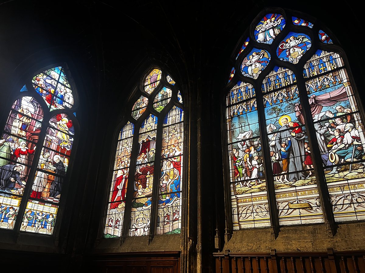 Richly coloured stained glass windows inside a historic Paris church