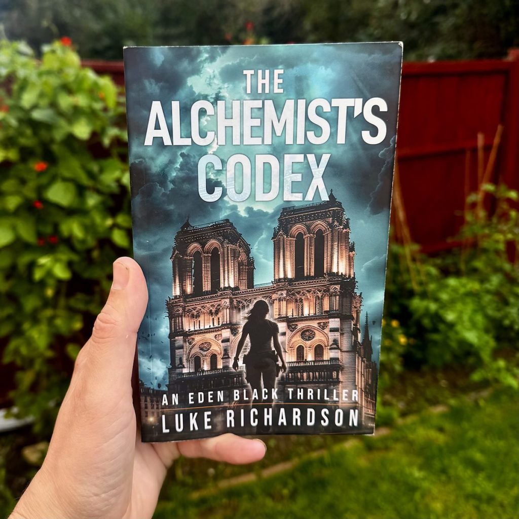 The Alchemist’s Codex paperback by Luke Richardson, an Eden Black thriller with Notre-Dame de Paris on the cover